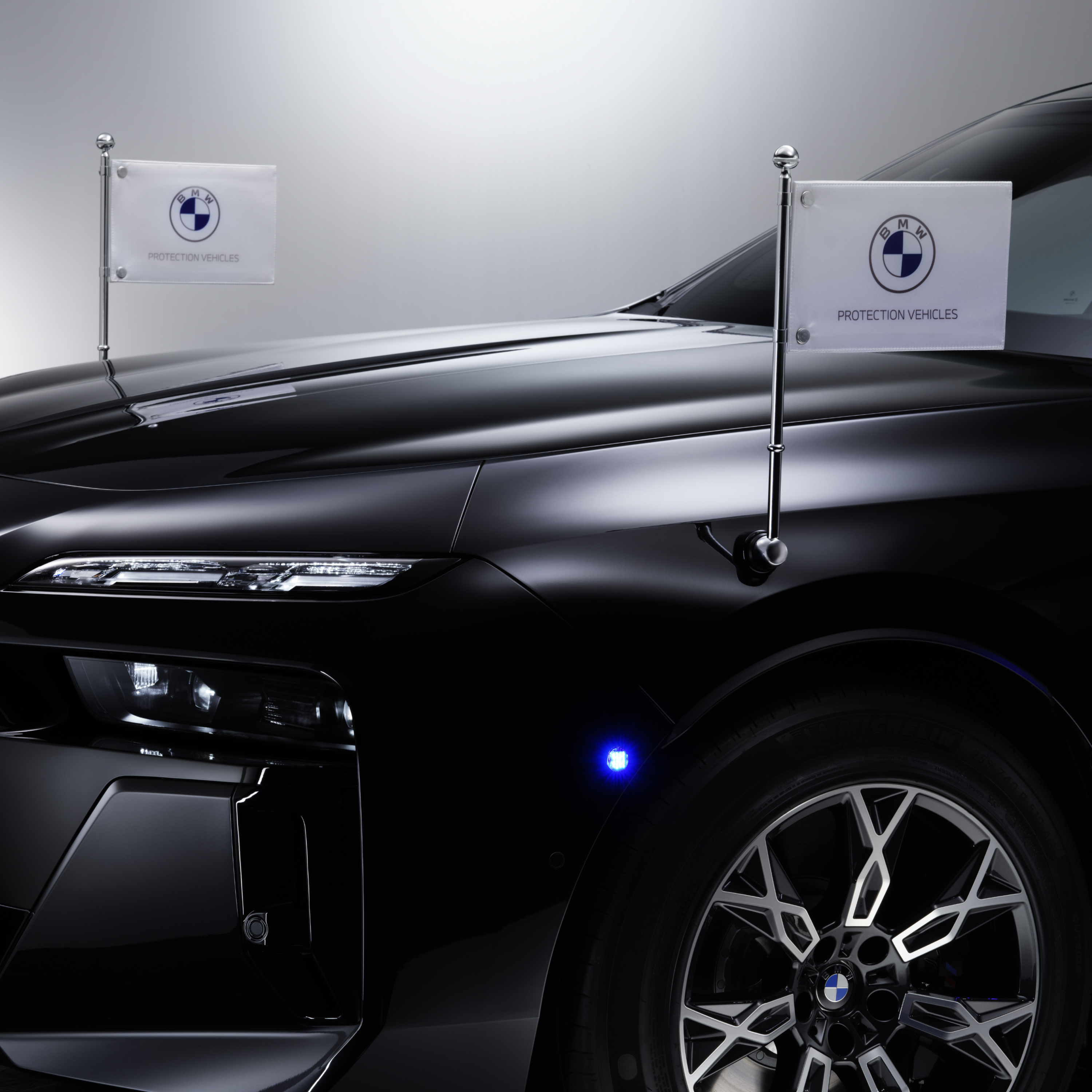 BMW sa krupnim kadrom dva nosača zastavice sa prednje strane vozila