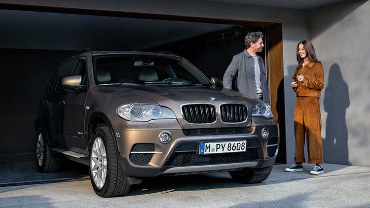 BMW Value Service čovek i žena ispred garaže pored modela BMW X5